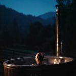 Woman,Bathes,Alone,In,Open-air,Bath,With,Night,Mountains,View.